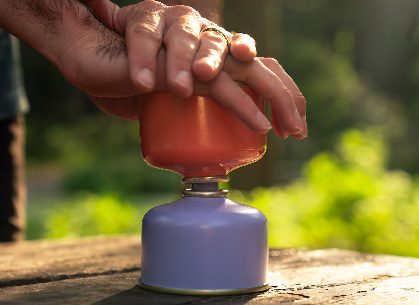 Demonstration of fuel transfer valve in use, with canister on bottom and user pressing top canister down